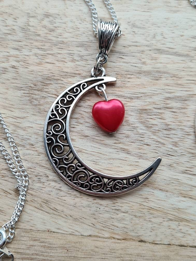 Crescent moon pendant with heart drop