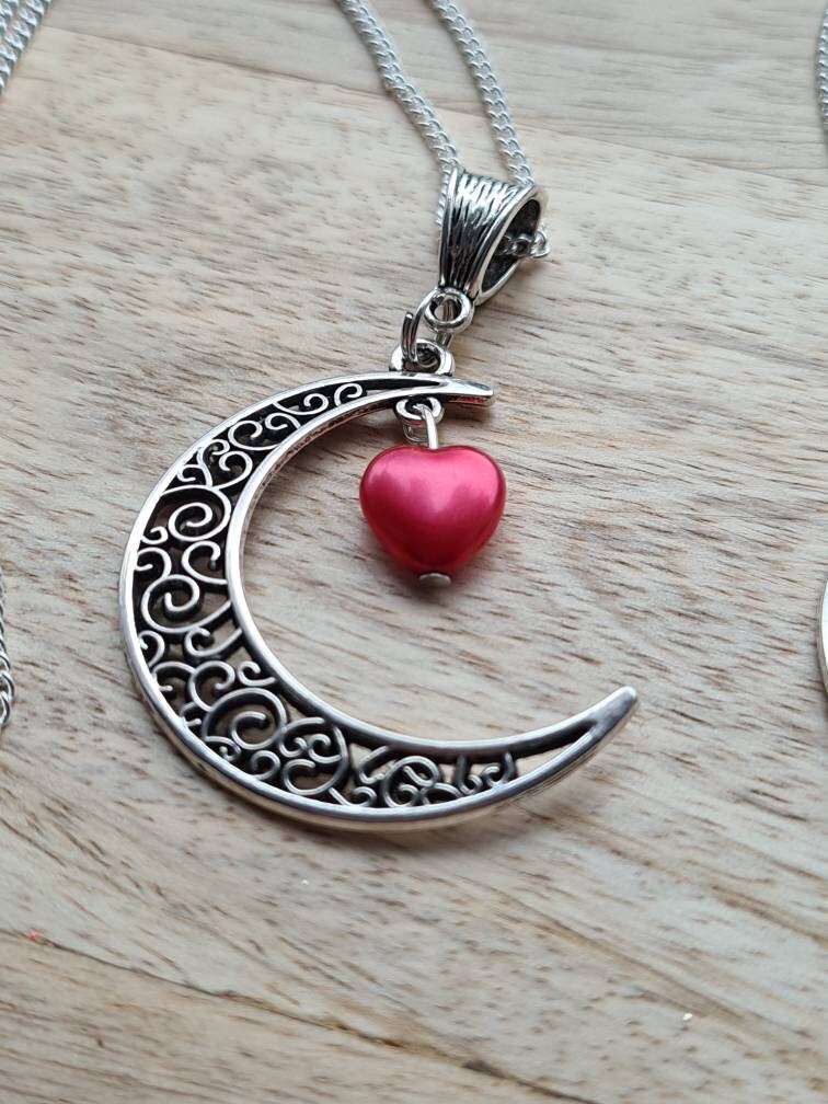 Crescent moon pendant with heart drop